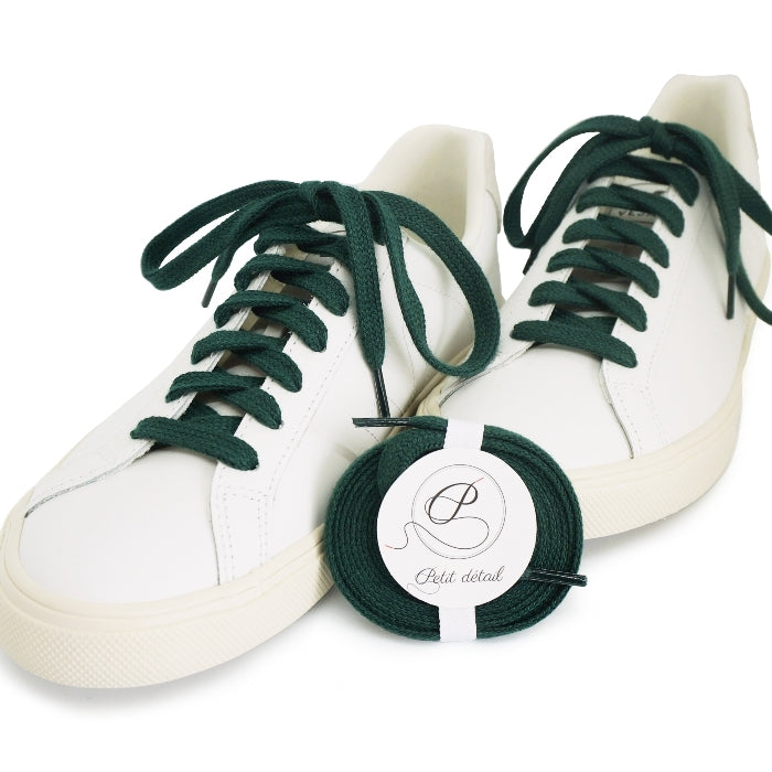 Lacets en coton biologique certifié GOTS Vert Intense - paire emballée avec une autre paire mise en scène sur des sneakers - Paire faisant partie d’un ensemble Lacets Made in France et Bouton de Manchette - vue de face - Petit-détail.com 